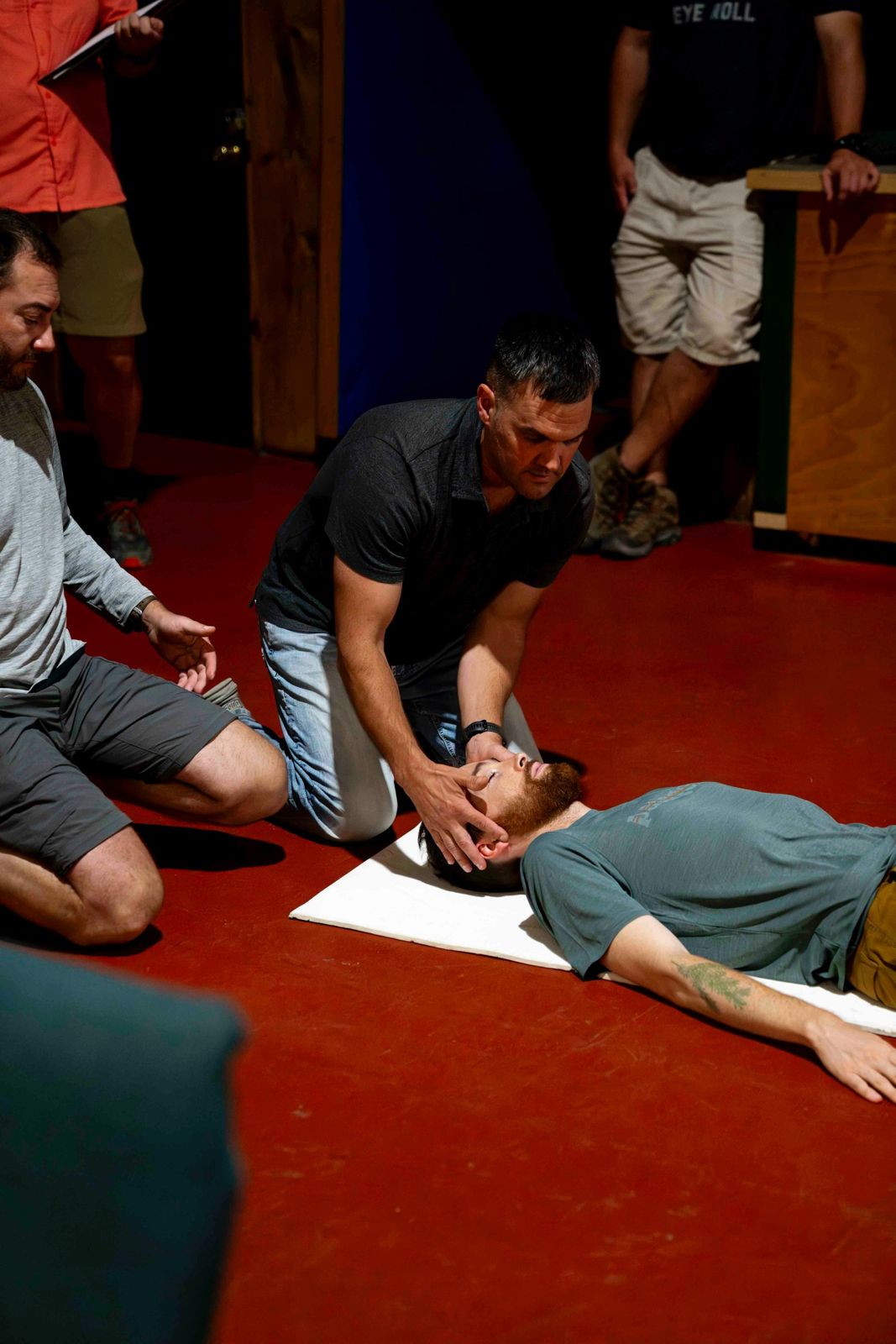 Class practising CPR on a volunteer